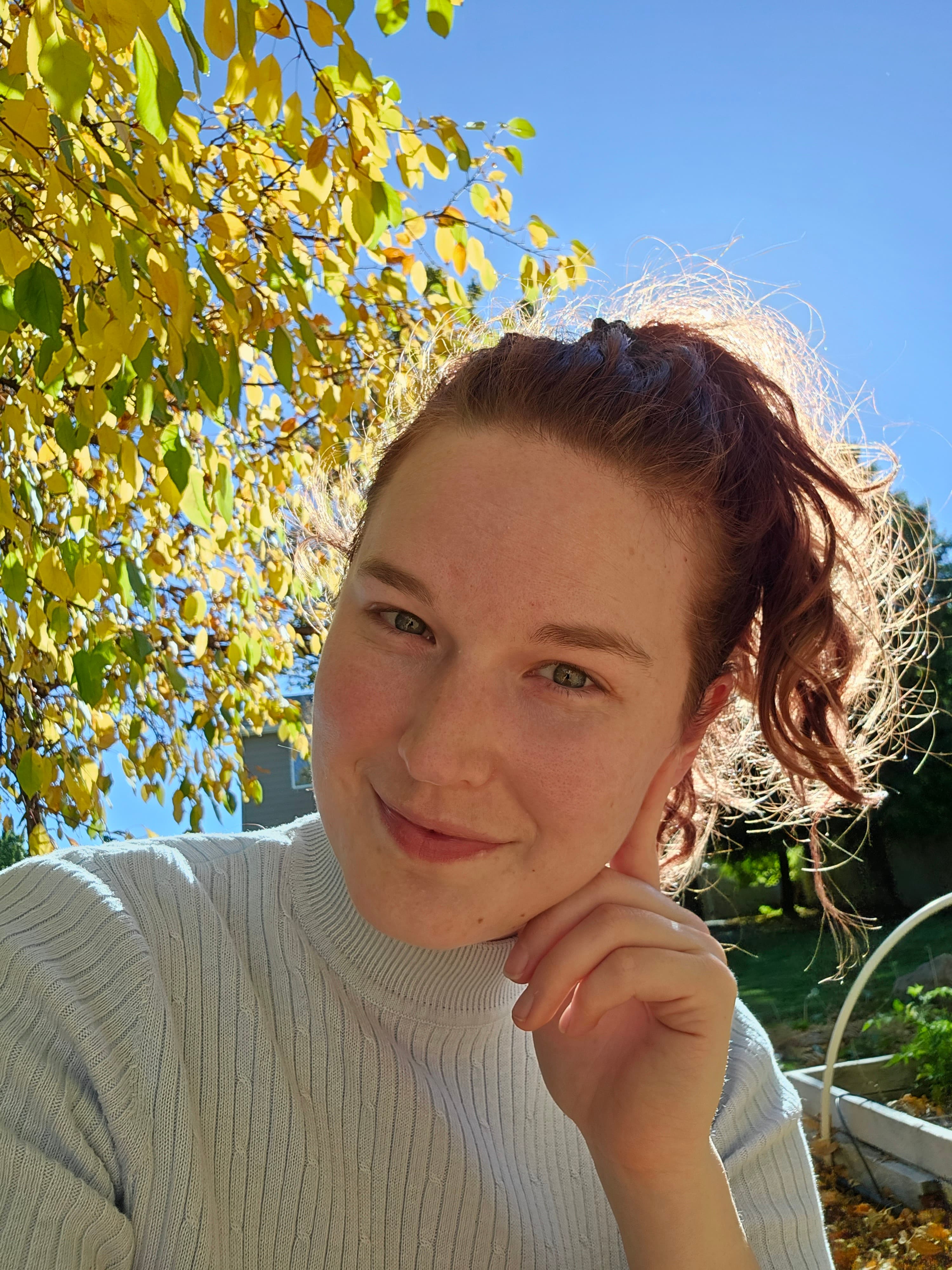 McKenzie sitting in her garden on a summer day